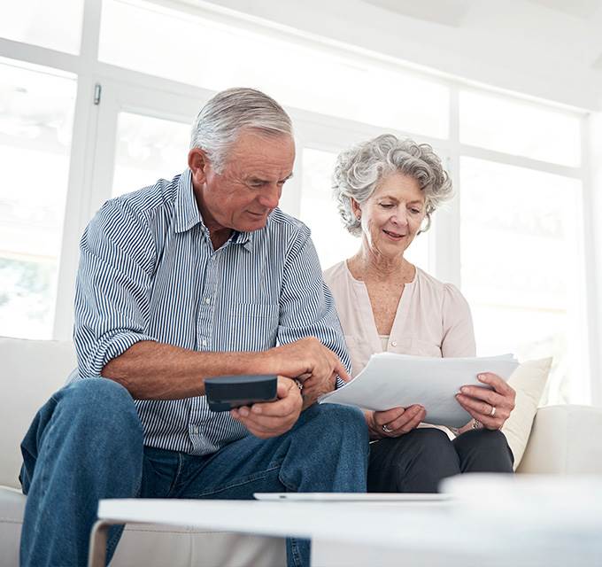 A retired couple looking over some papers
